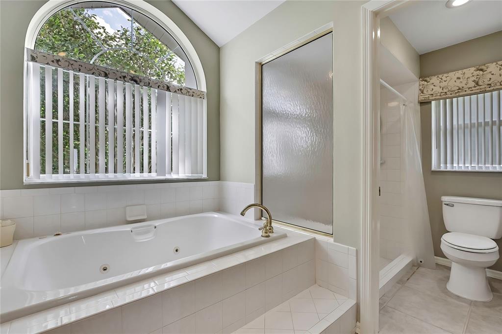 3275 West Daffodil Drive Dunnellon, FL 34433 - Photo 33 of 67 a bathroom with a bathtub and a shower