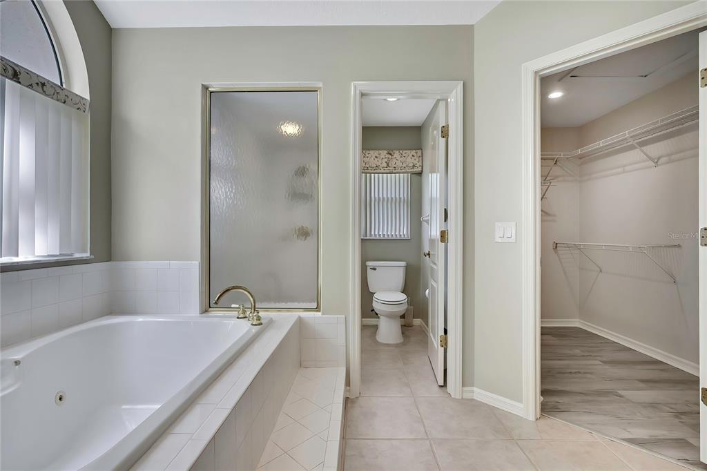 3275 West Daffodil Drive Dunnellon, FL 34433 - Photo 34 of 67 a bathroom with a tub a toilet and a shower