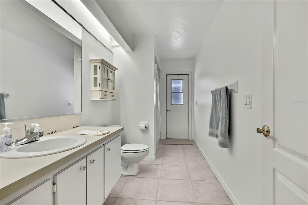 3275 West Daffodil Drive Dunnellon, FL 34433 - Photo 38 of 67 a bathroom with a granite countertop sink toilet and shower