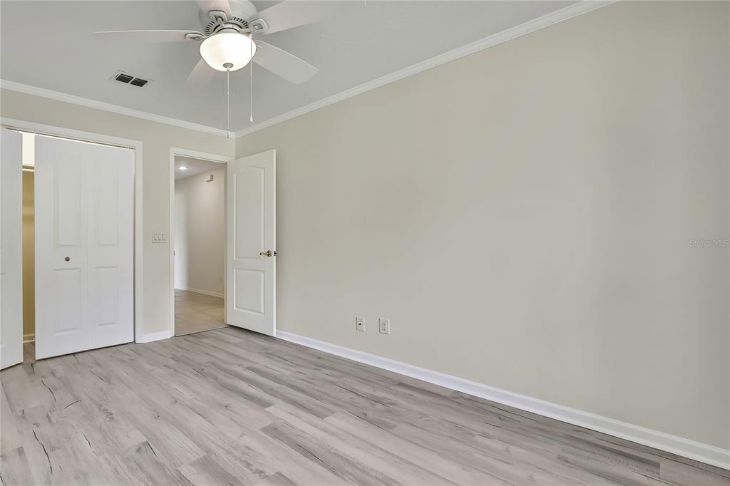 3275 West Daffodil Drive Dunnellon, FL 34433 - Photo 41 of 67 an empty room with wooden floor and fan
