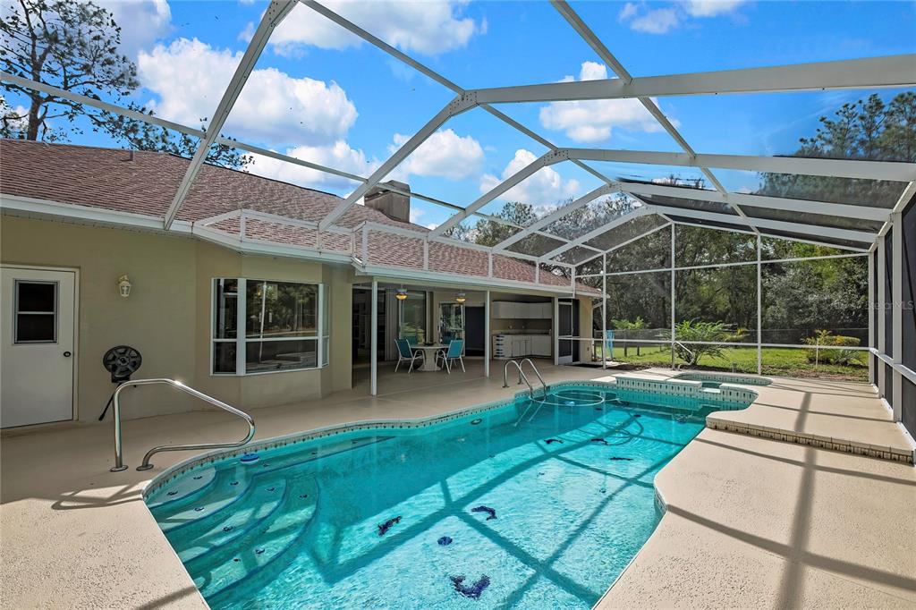 3275 West Daffodil Drive Dunnellon, FL 34433 - Photo 46 of 67 a view of a house with a backyard porch and sitting area
