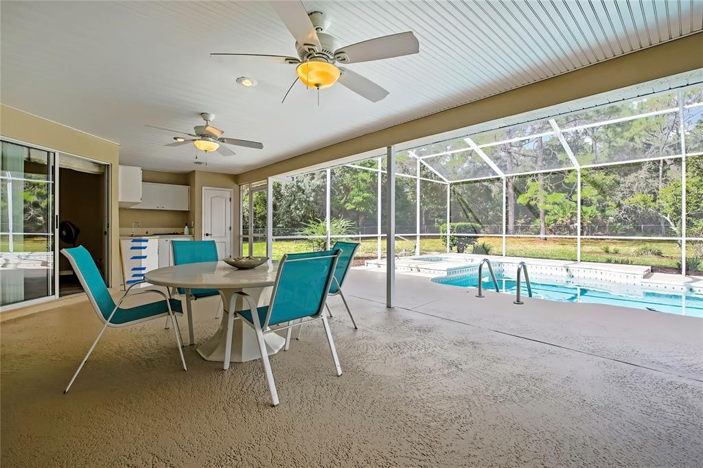 3275 West Daffodil Drive Dunnellon, FL 34433 - Photo 47 of 67 a view of a dining room with furniture a chandelier and a large window