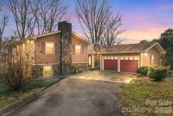 a view of a house with a yard and garage