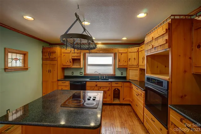 a kitchen with stainless steel appliances granite countertop a stove and a sink