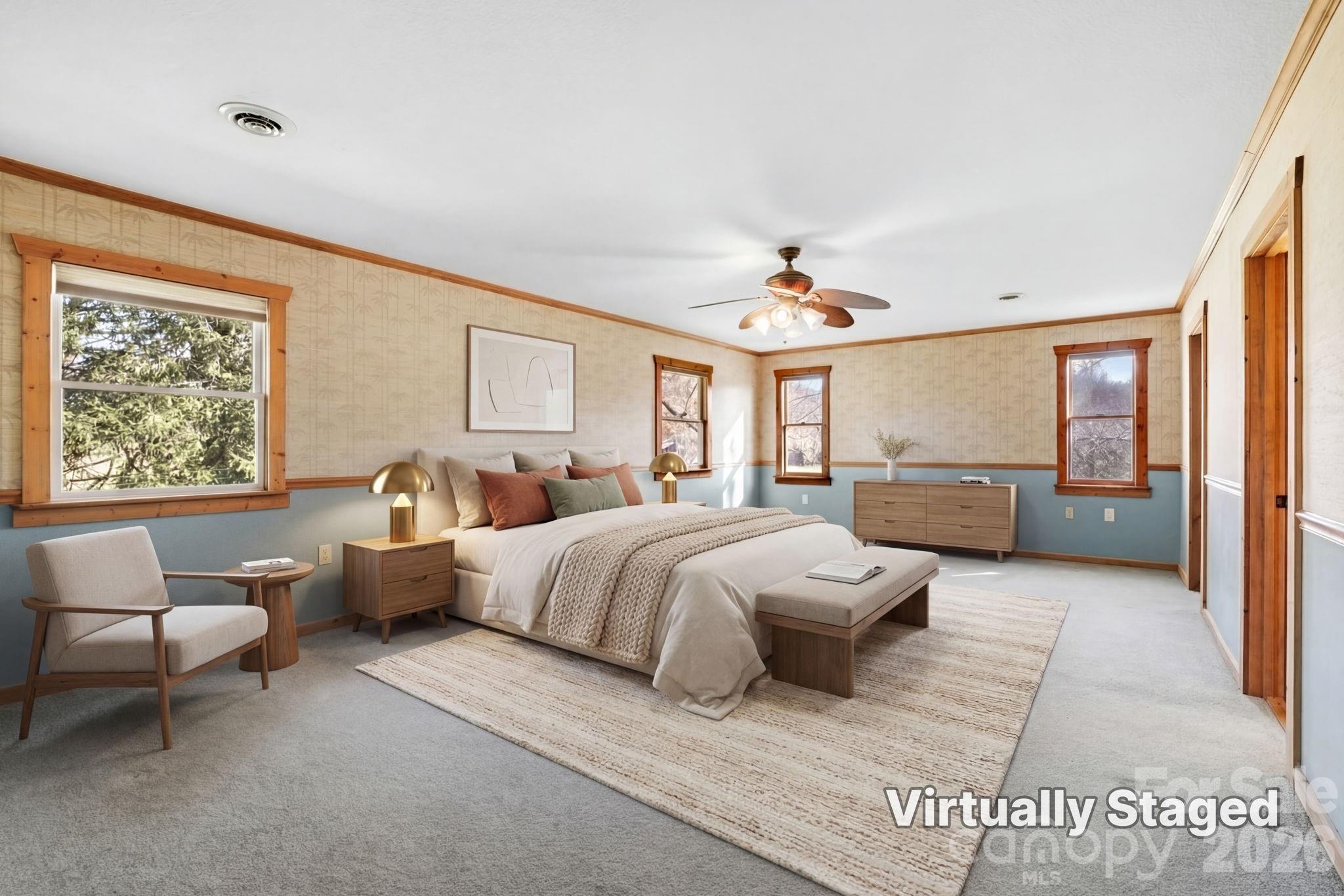 1644 West Deep Creek Road Bryson City, NC 28713 - Photo 13 of 47 a spacious bedroom with a large bed and a chandelier