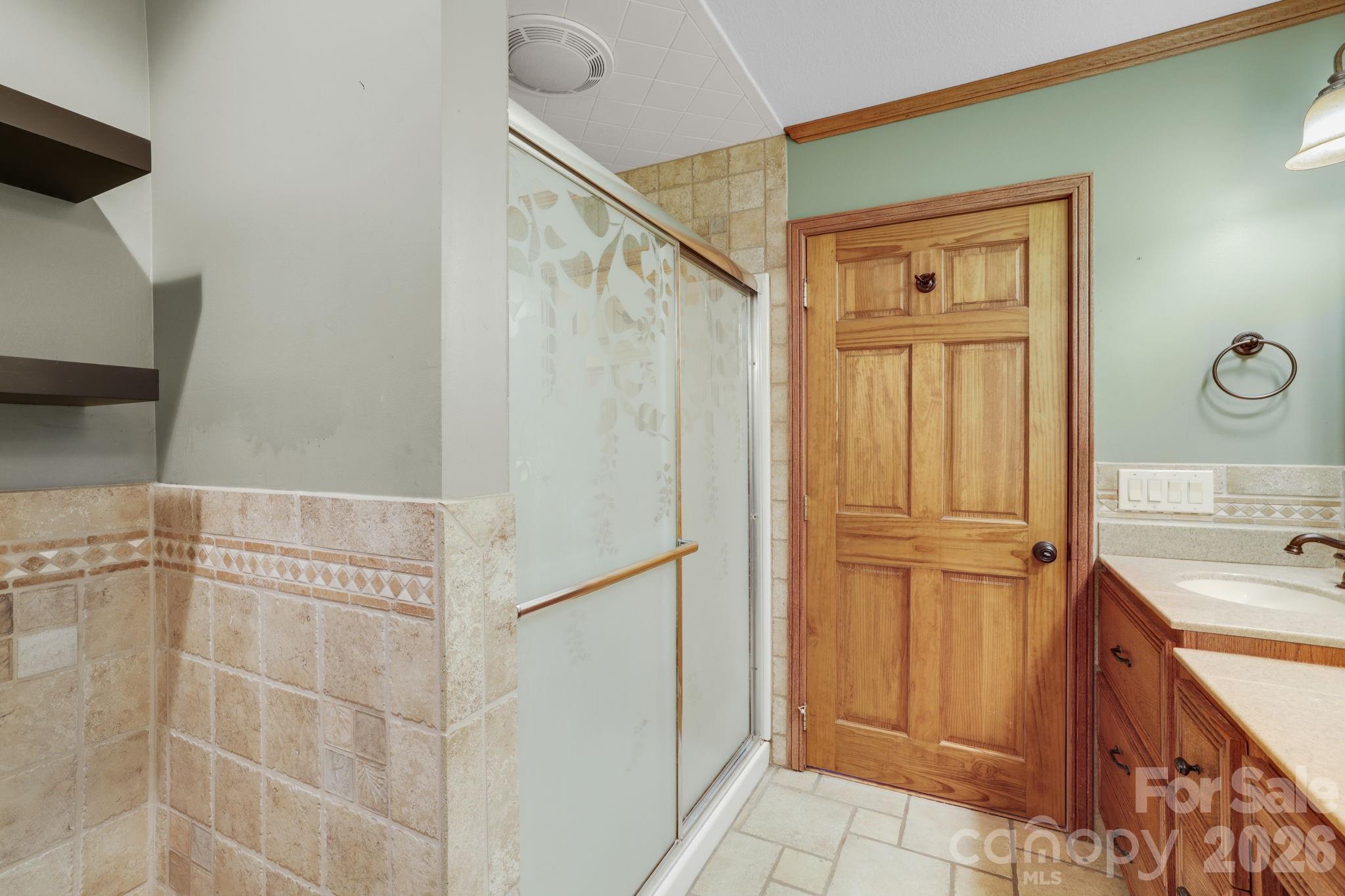 1644 West Deep Creek Road Bryson City, NC 28713 - Photo 18 of 47 a bathroom with a sink and a shower