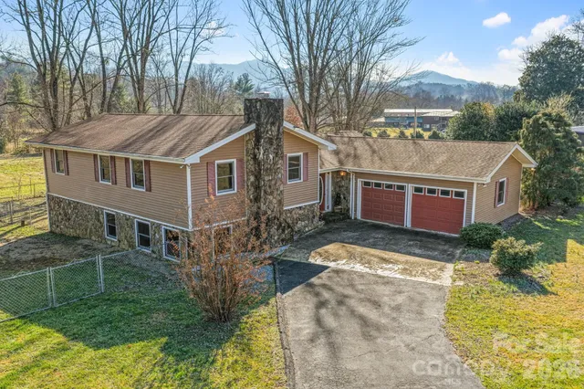 a view of a house with a yard and sitting area