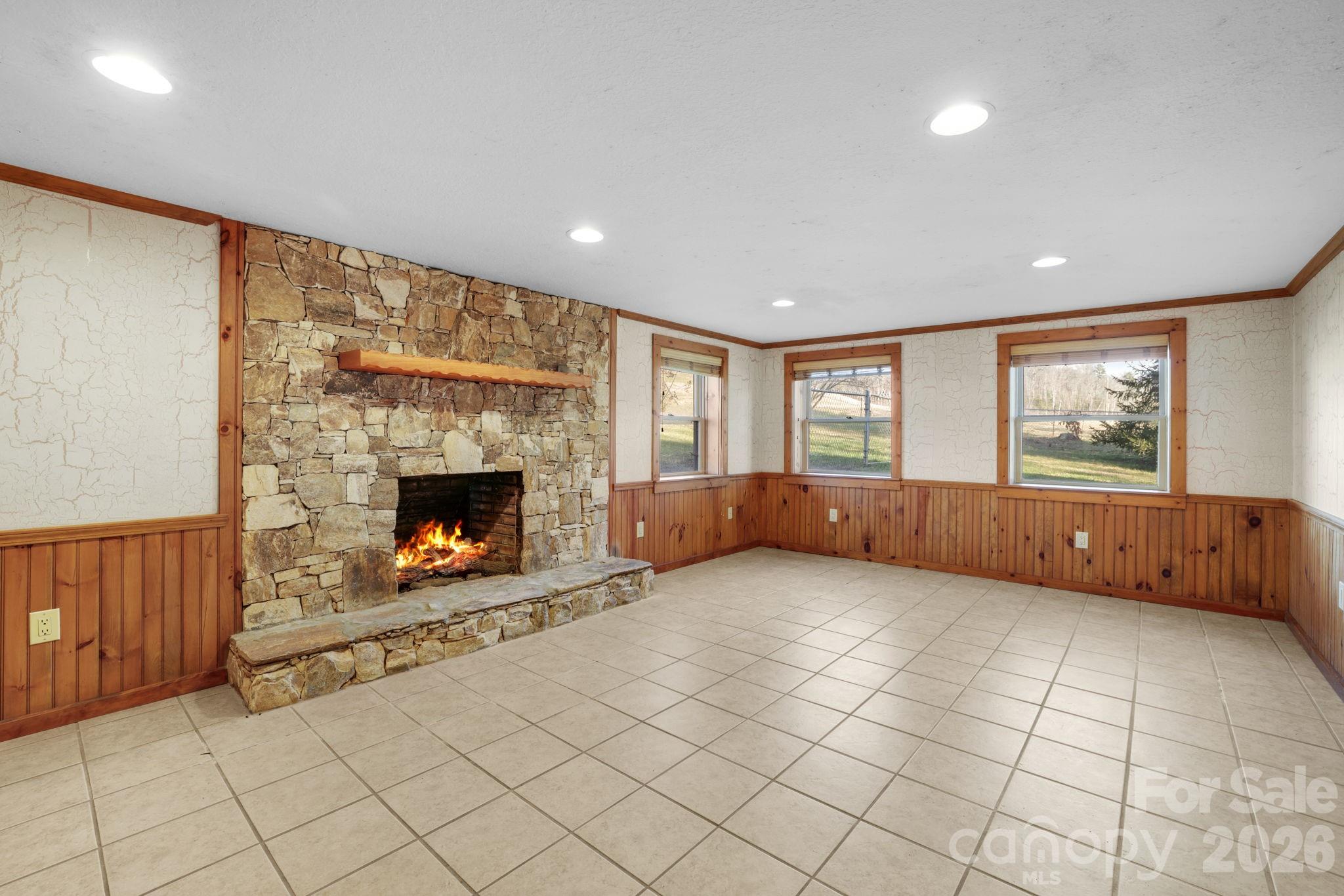 1644 West Deep Creek Road Bryson City, NC 28713 - Photo 25 of 47 a view of an empty room with a fireplace and a window