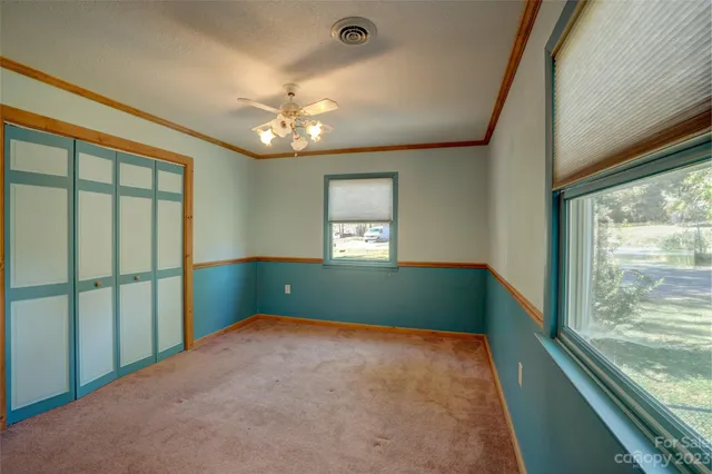 a view of an empty room with a ceiling fan