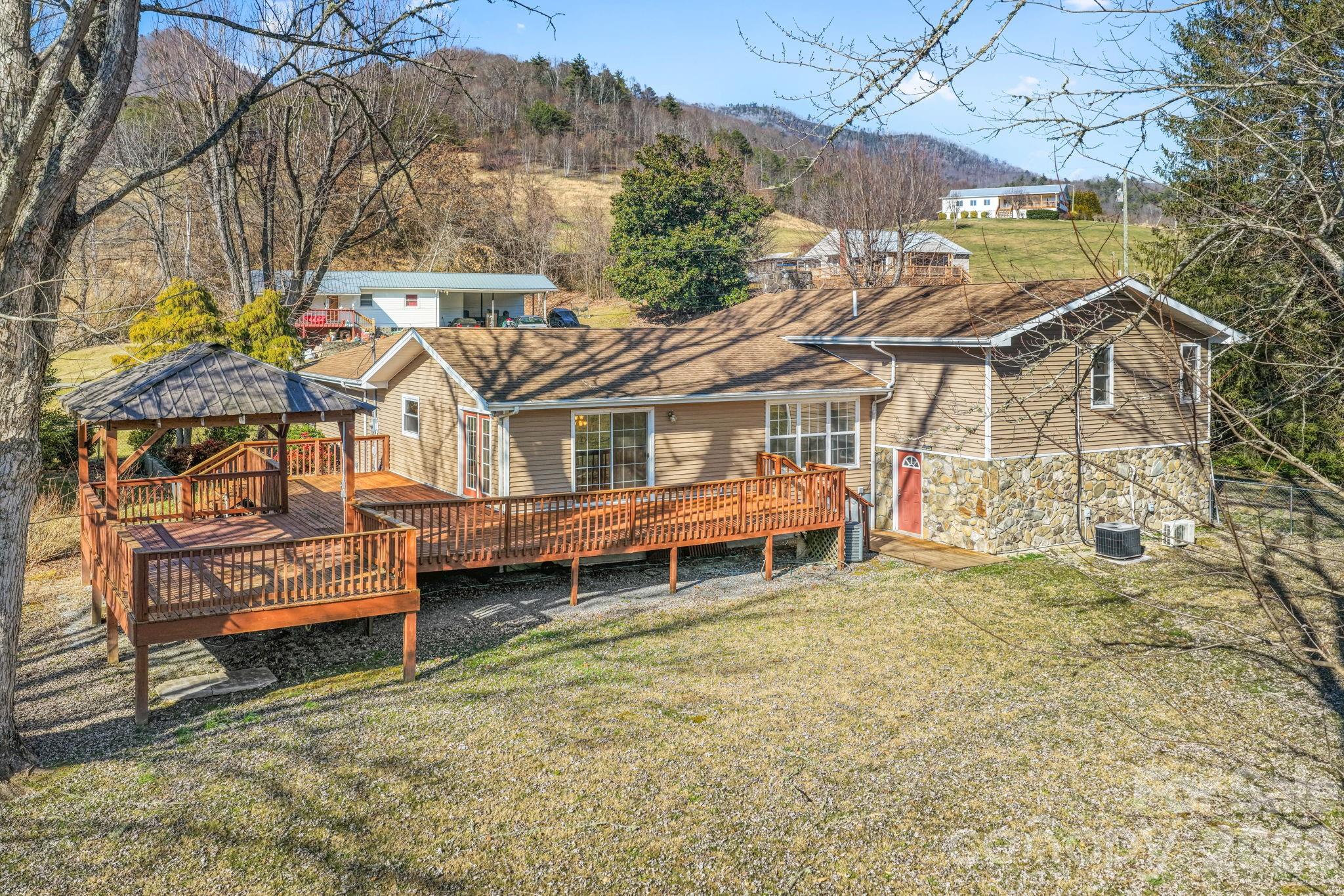 1644 West Deep Creek Road Bryson City, NC 28713 - Photo 3 of 47 a view of a house with a yard and sitting area