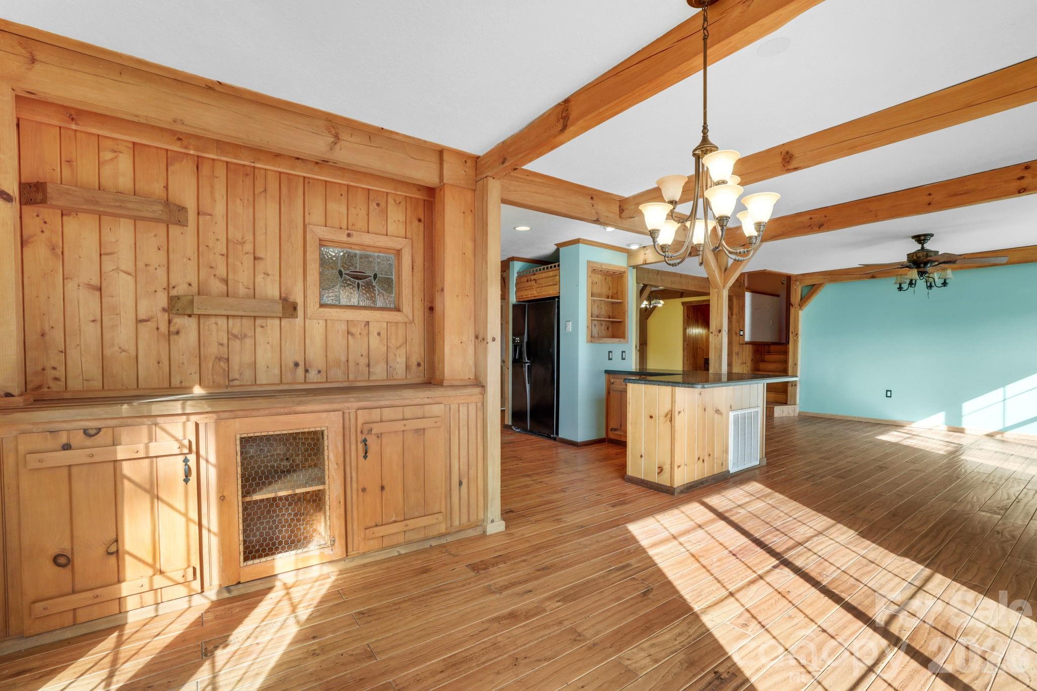 1644 West Deep Creek Road Bryson City, NC 28713 - Photo 7 of 47 a view of a kitchen with kitchen island stainless steel appliances wooden floor and living room view