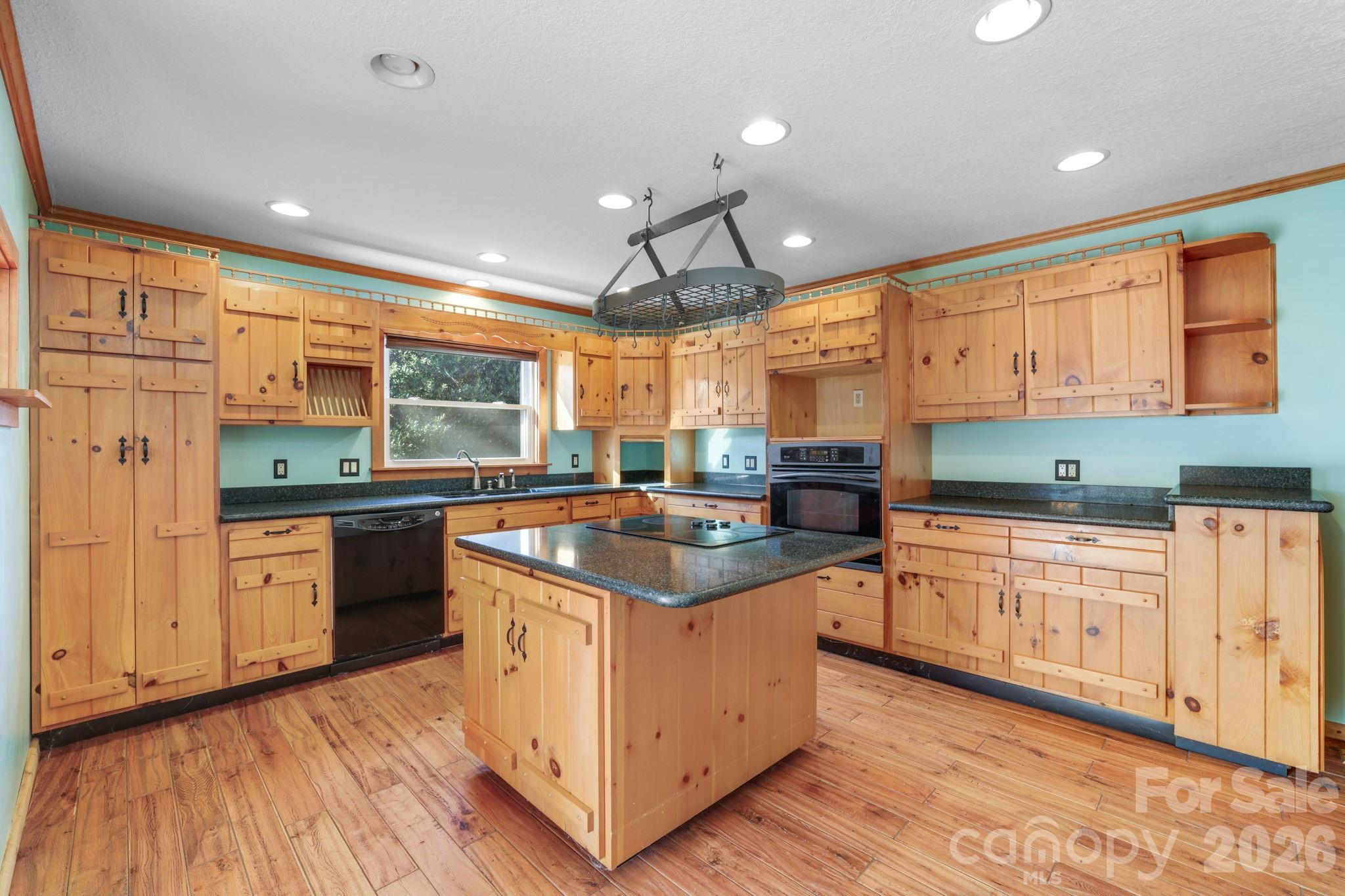 1644 West Deep Creek Road Bryson City, NC 28713 - Photo 8 of 47 a kitchen with stainless steel appliances granite countertop a stove and cabinets