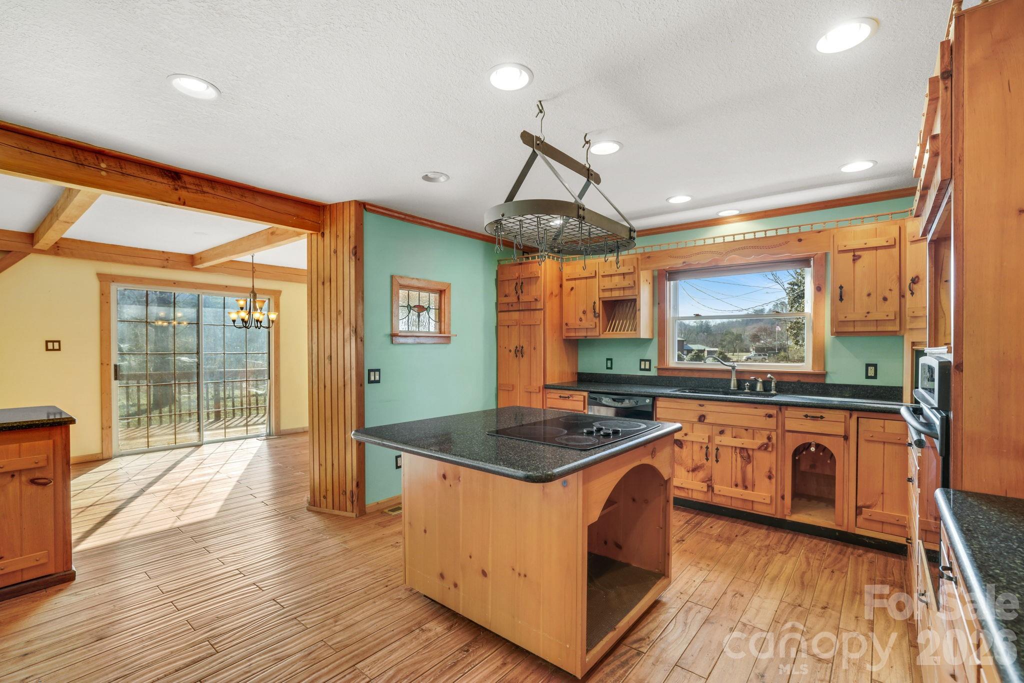 1644 West Deep Creek Road Bryson City, NC 28713 - Photo 9 of 47 a kitchen with stainless steel appliances granite countertop a stove a sink and a refrigerator
