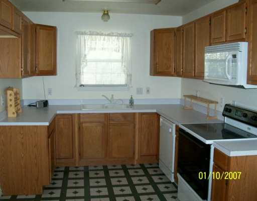 3826 Matteson Street Corpus Christi, TX 78418 - Photo 4 of 8 a kitchen with sink a window and cabinets