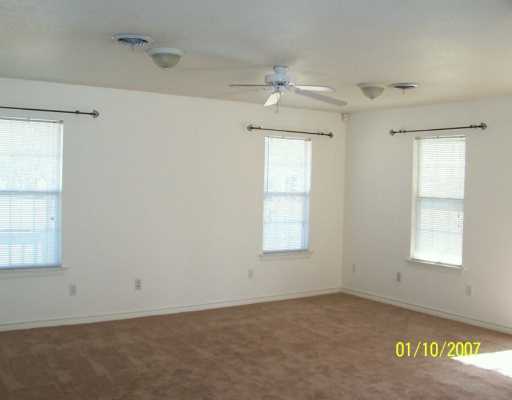 3826 Matteson Street Corpus Christi, TX 78418 - Photo 6 of 8 an empty room with windows and fan