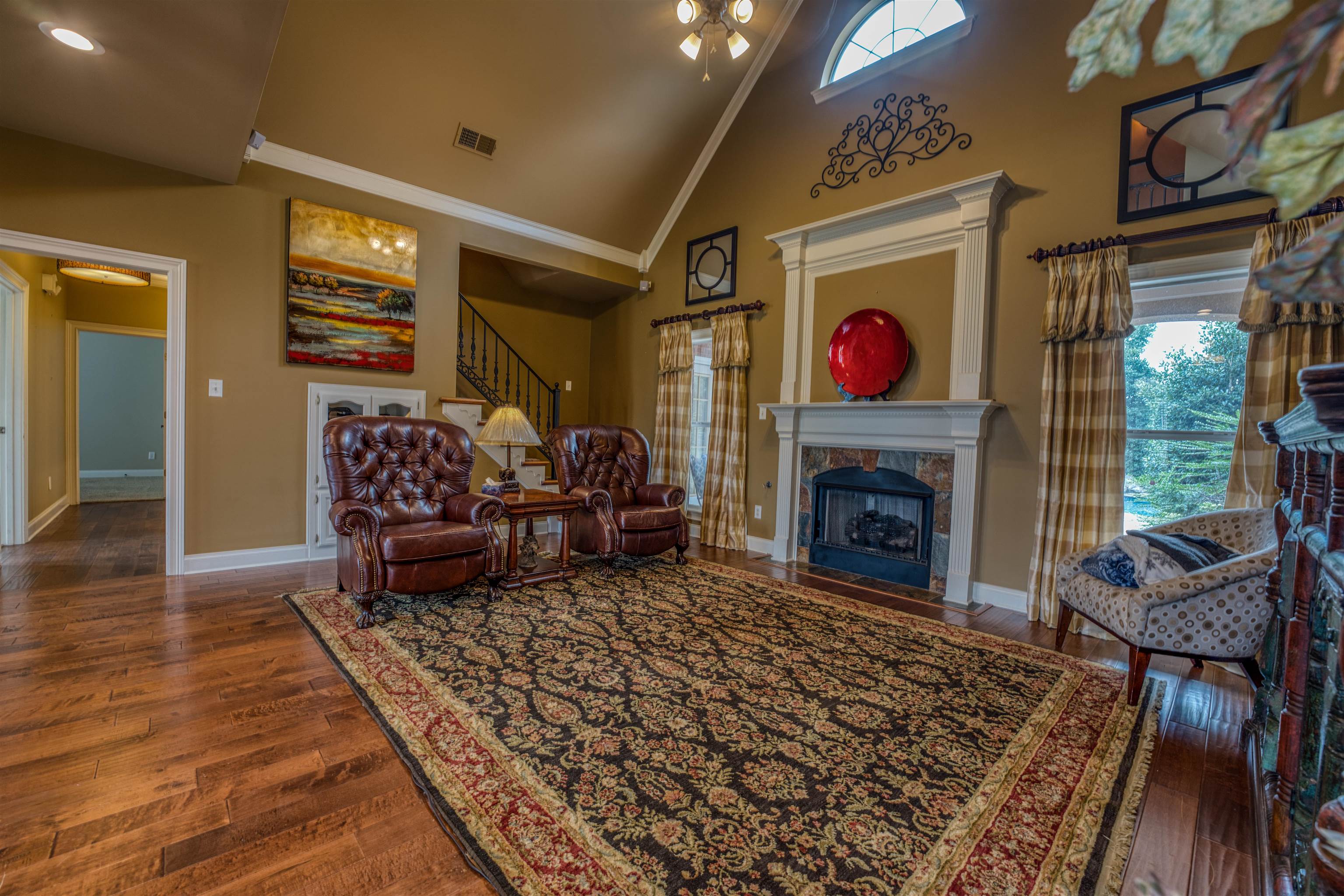 215 Walker Lake Road Atoka, TN 38004 - Photo 8 of 38 Living room featuring crown molding, a fireplace, dark hardwood / wood-style floors, and high vaulted ceiling