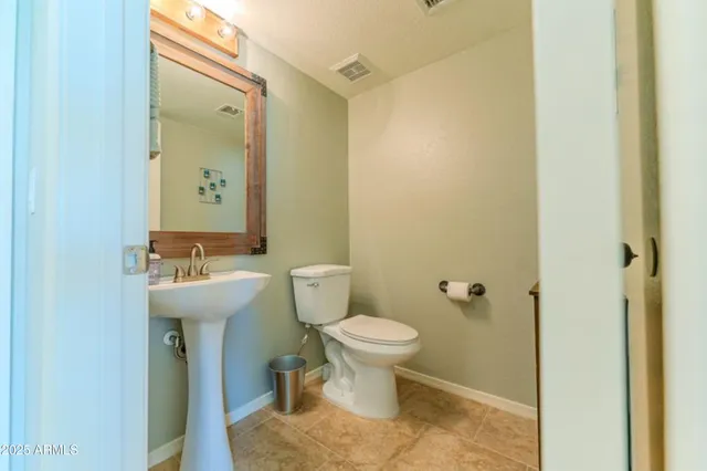 a bathroom with a sink toilet and a mirror
