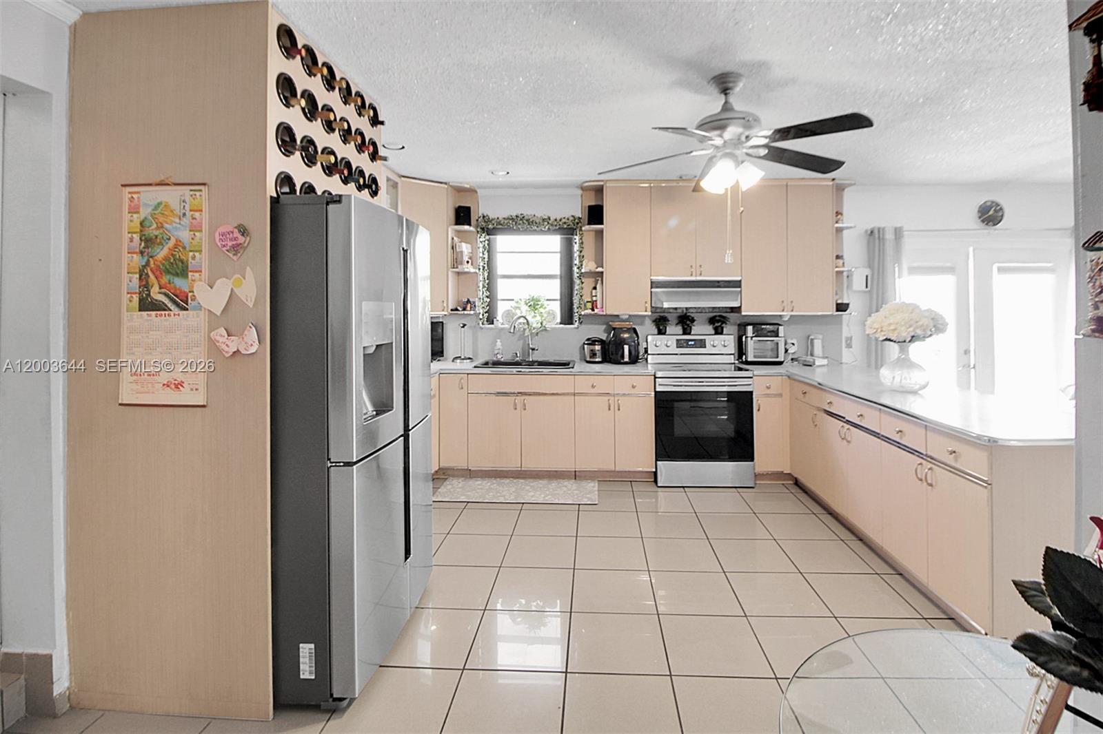 19100 Southwest 125th Avenue Miami, FL 33177 - Photo 16 of 46 a kitchen with stainless steel appliances a refrigerator sink and cabinets