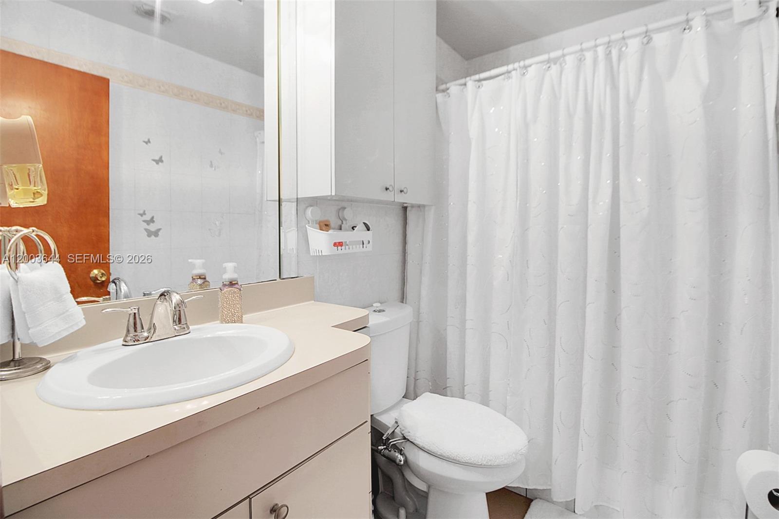 19100 Southwest 125th Avenue Miami, FL 33177 - Photo 24 of 46 a bathroom with a sink toilet and a mirror