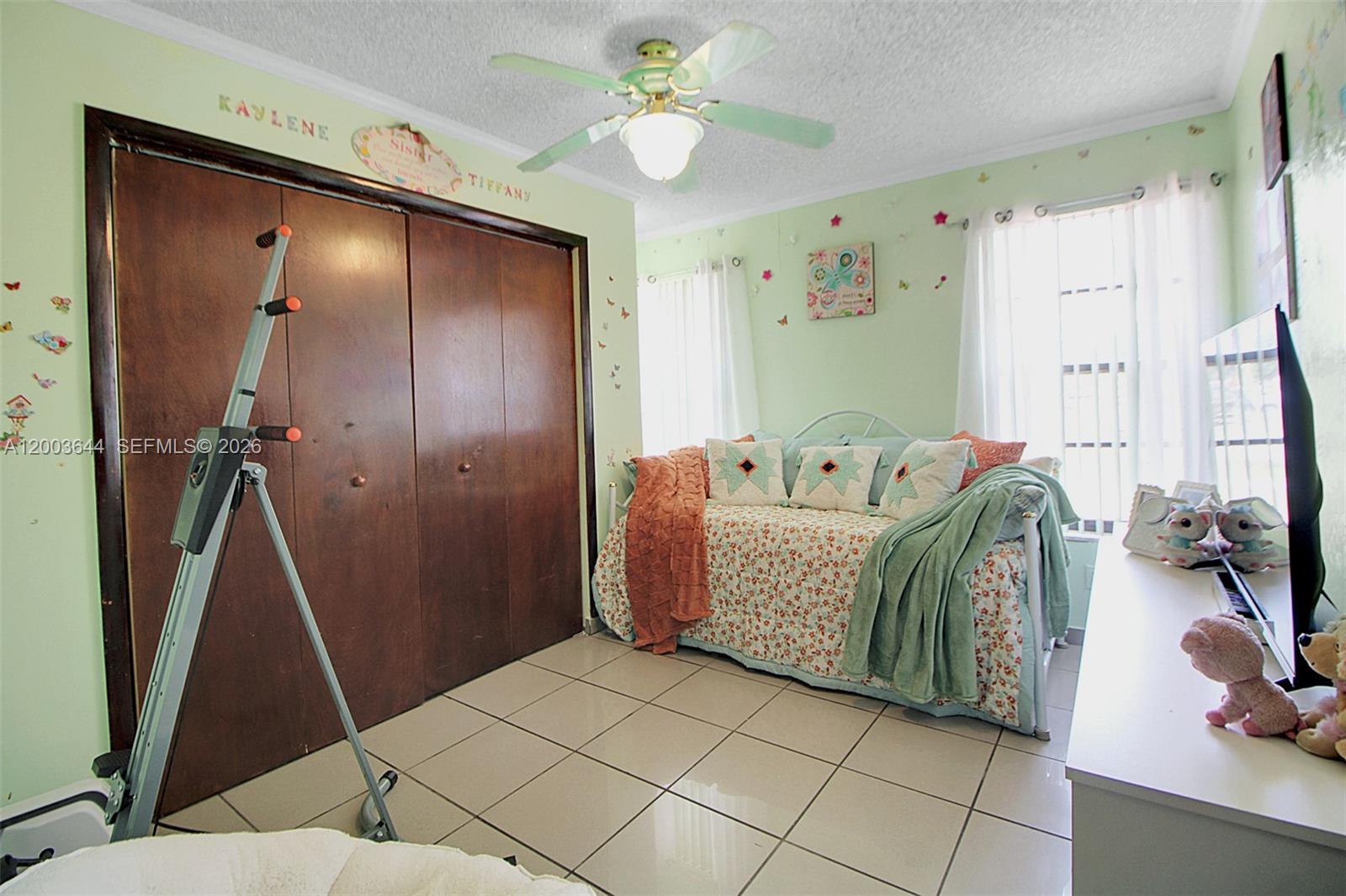19100 Southwest 125th Avenue Miami, FL 33177 - Photo 26 of 46 a bedroom with a bed and a chandelier