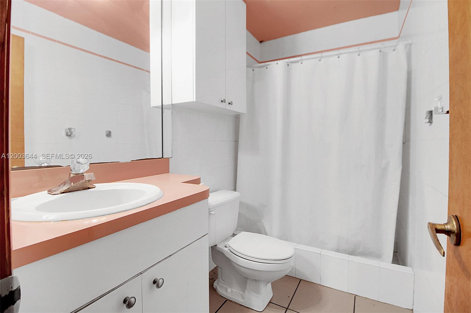 19100 Southwest 125th Avenue Miami, FL 33177 - Photo 28 of 46 a bathroom with a sink a toilet and shower curtain