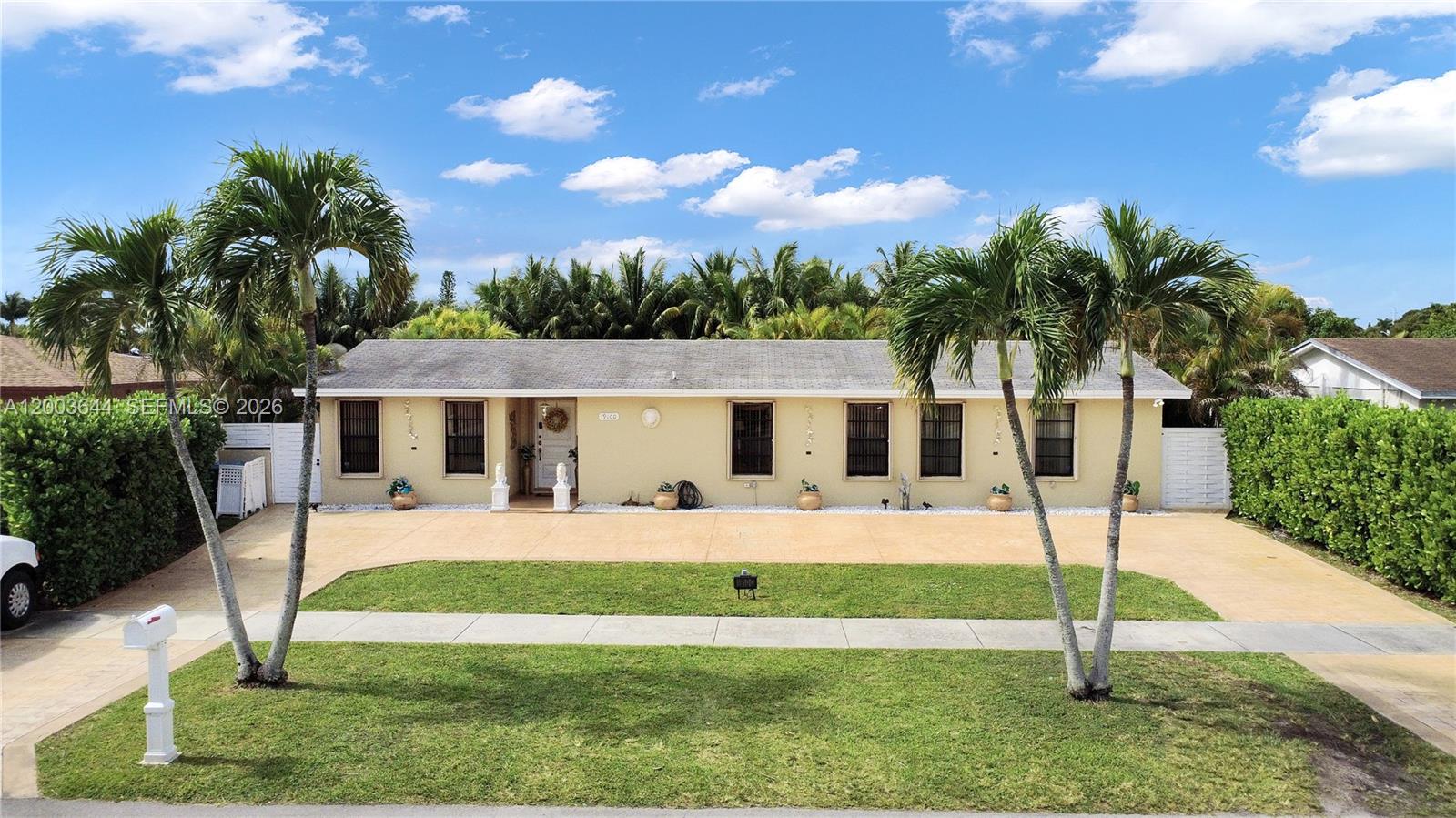 19100 Southwest 125th Avenue Miami, FL 33177 - Photo 3 of 46 a front view of a house with a yard
