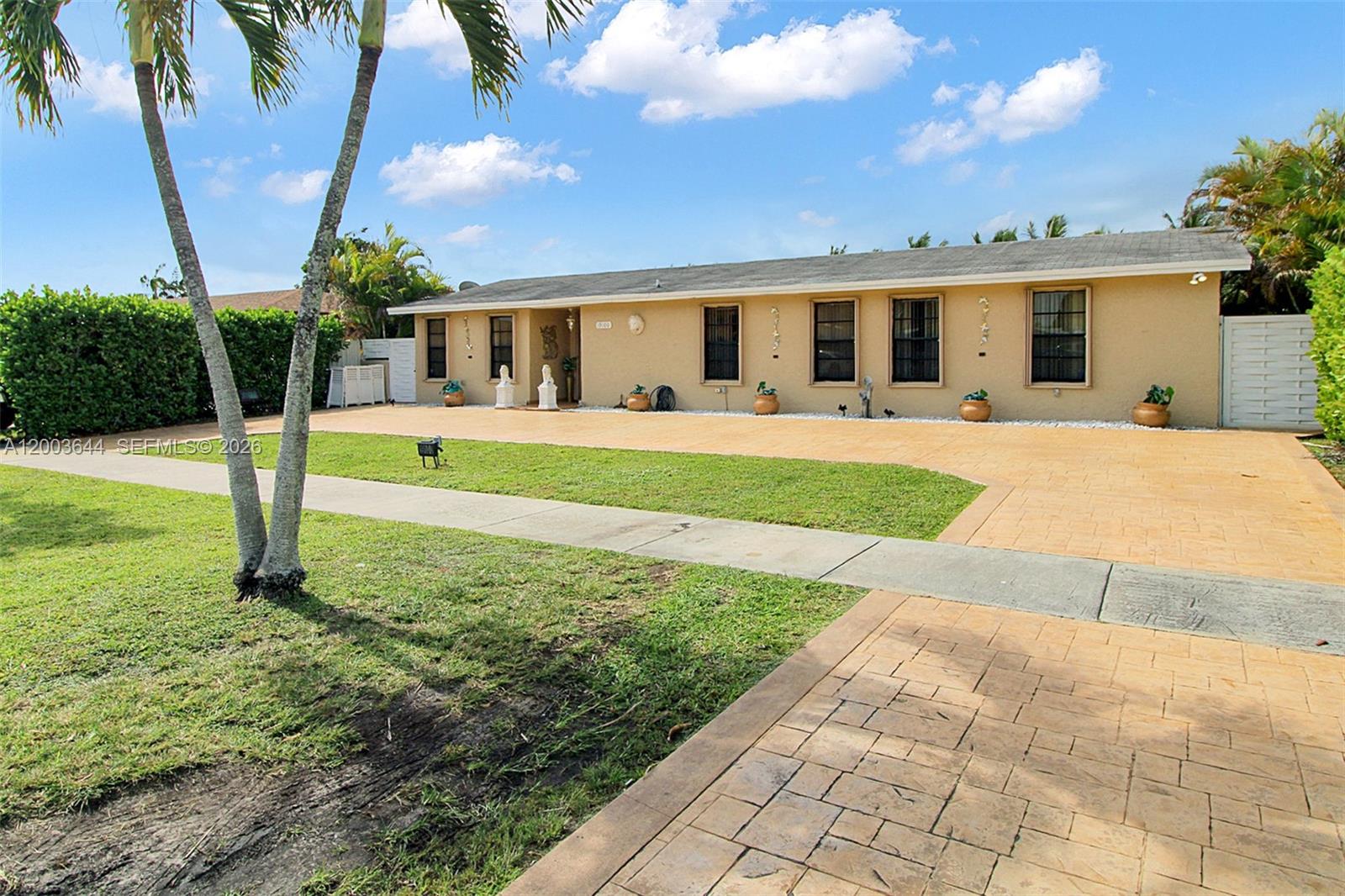 19100 Southwest 125th Avenue Miami, FL 33177 - Photo 9 of 46 a front view of house with garden and porch
