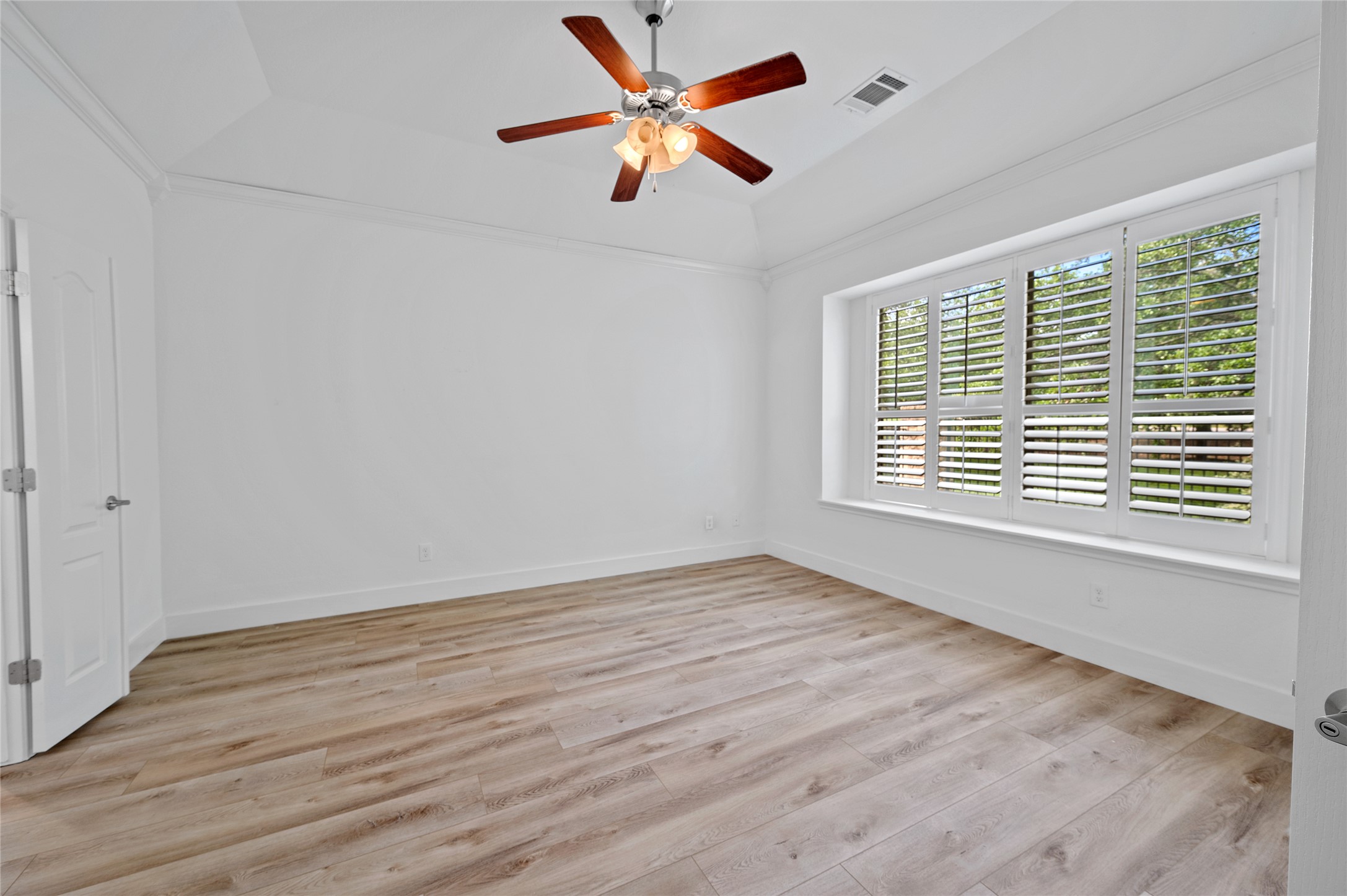 4512 Pyrenees Pass Bee Cave, TX 78738 - Photo 17 of 35 a view of an empty room with wooden floor and a window
