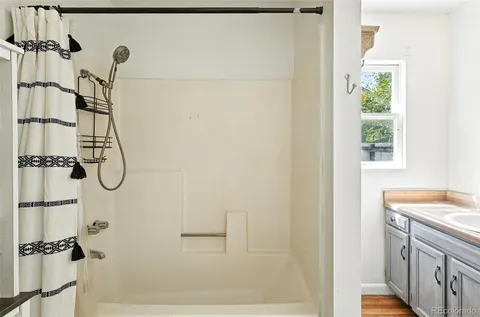 a bathroom with a granite countertop shower