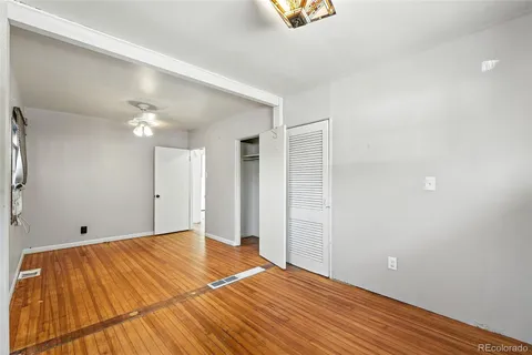 a view of an empty room with wooden floor