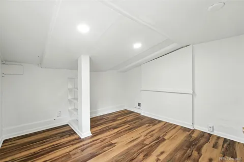 a view of a room with wooden floor
