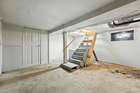 a room with a wooden floor and white walls