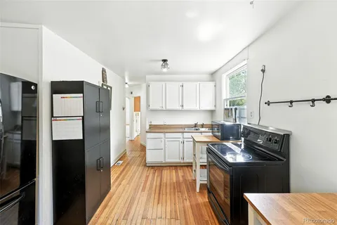 a kitchen with a refrigerator and a stove top oven