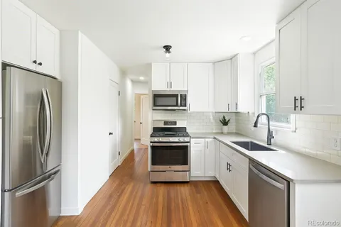 a kitchen with a sink stainless steel appliances and cabinets