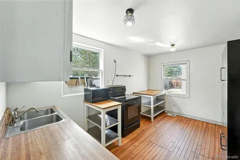 a room with furniture a window and wooden floor