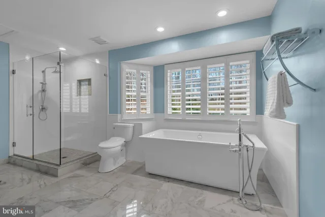 a view of hallway with mirror a sink and a mirror