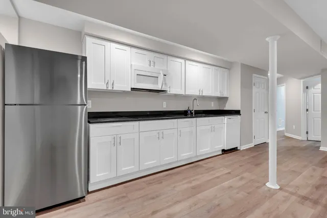 a bathroom with a sink and a washer dryer
