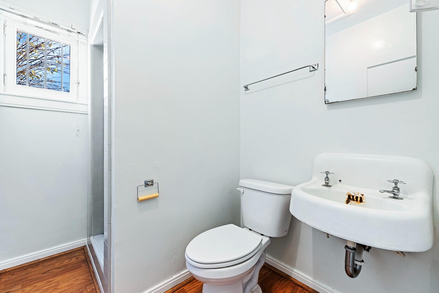 235 North Fulton Street Fresno, CA 93701 - Photo 24 of 43 a white toilet sitting next to a bathroom sink