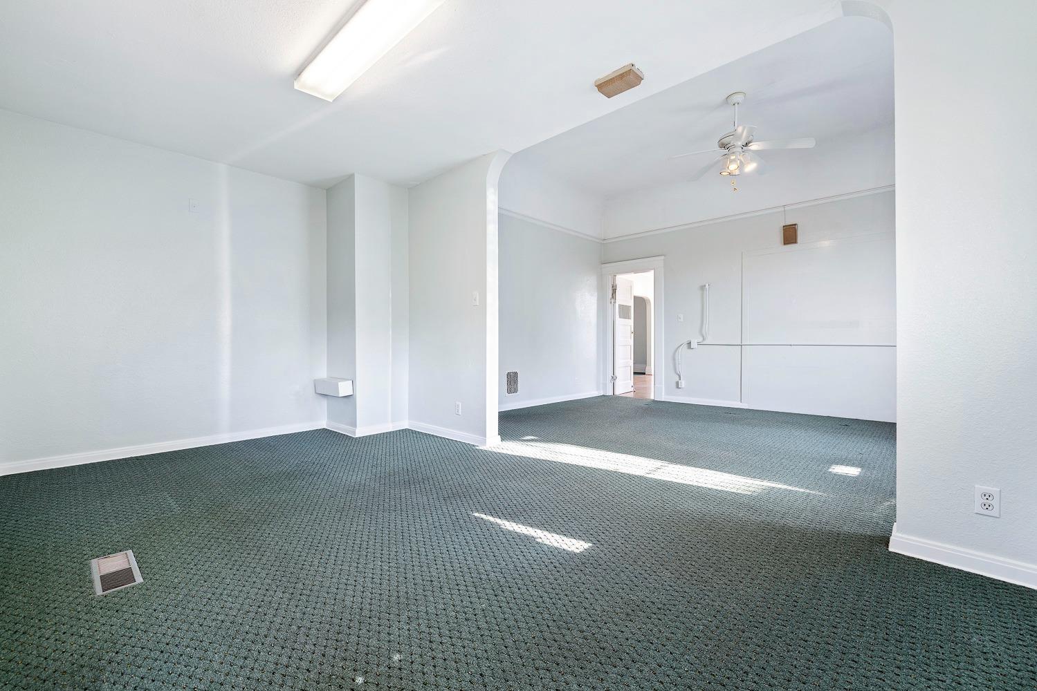 235 North Fulton Street Fresno, CA 93701 - Photo 32 of 43 a view of a livingroom with an empty space and a window