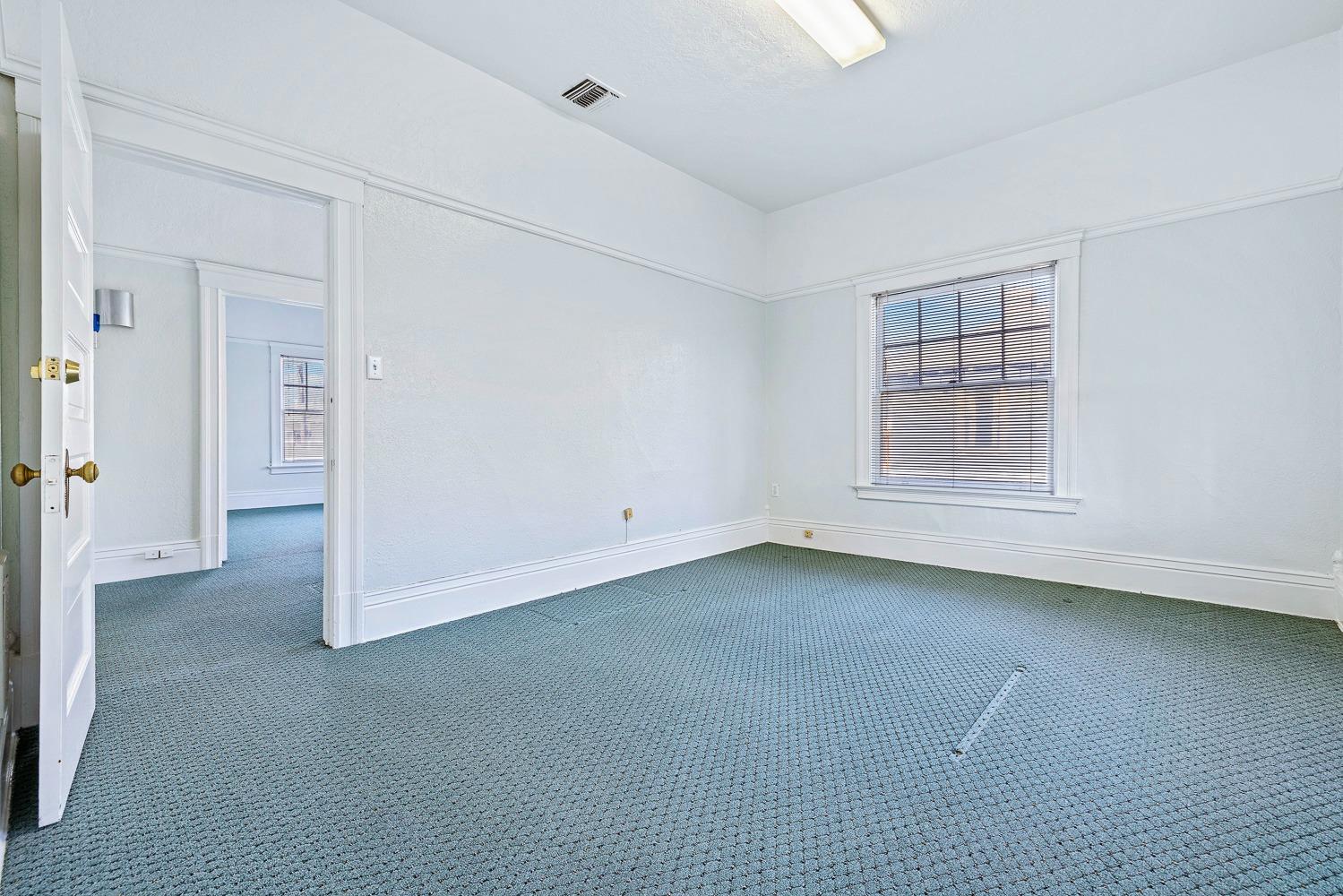 235 North Fulton Street Fresno, CA 93701 - Photo 41 of 43 an empty room with a empty space and windows