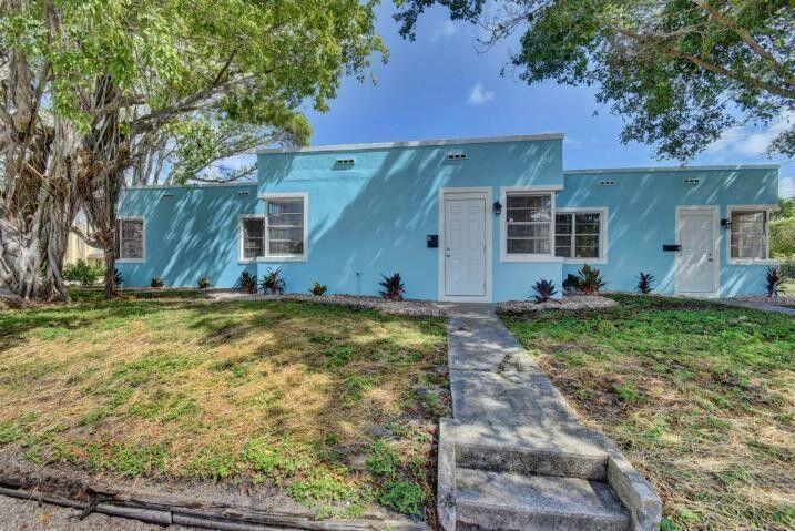 3000 Broadway Avenue, Unit 3 West Palm Beach, FL 33407 - Photo 16 of 19 a house with trees in front of it