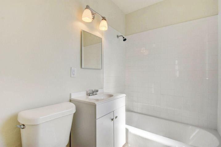 3000 Broadway Avenue, Unit 3 West Palm Beach, FL 33407 - Photo 7 of 19 a bathroom with a sink a toilet and shower