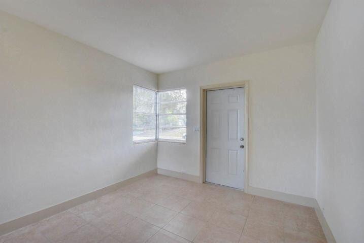 3000 Broadway Avenue, Unit 3 West Palm Beach, FL 33407 - Photo 9 of 19 a view of an empty room with a window