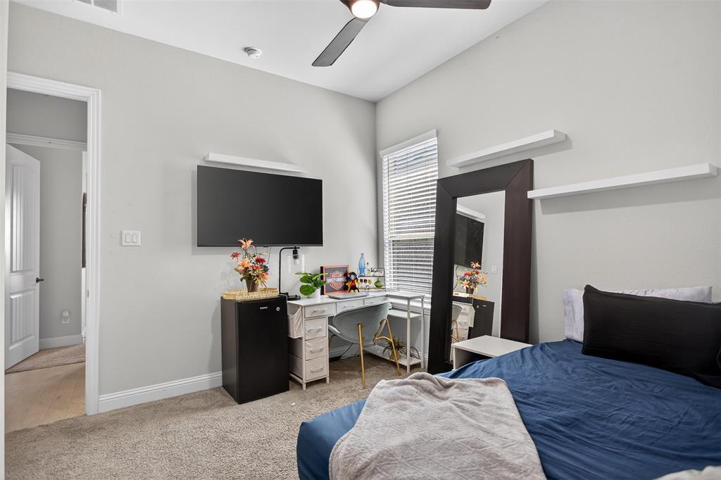 6829 Danridge Road Rowlett, TX 75089 - Photo 18 of 28 a view of a workspace with furniture and a flat screen tv
