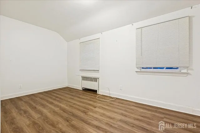 a view of a room with wooden floor