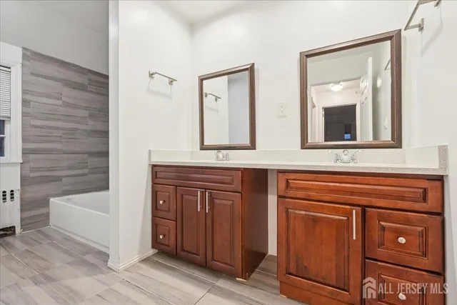 a bathroom with a sink a mirror and a bathtub