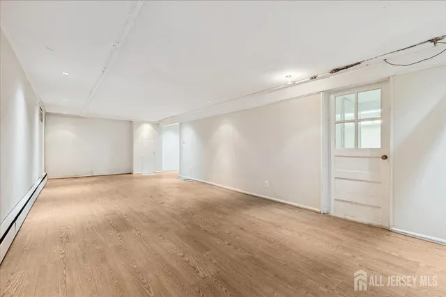 an empty room with windows and closet