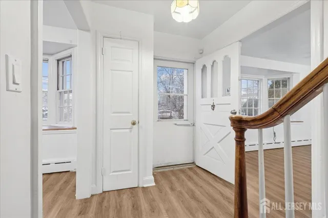 a view of entryway with wooden floor and stairs