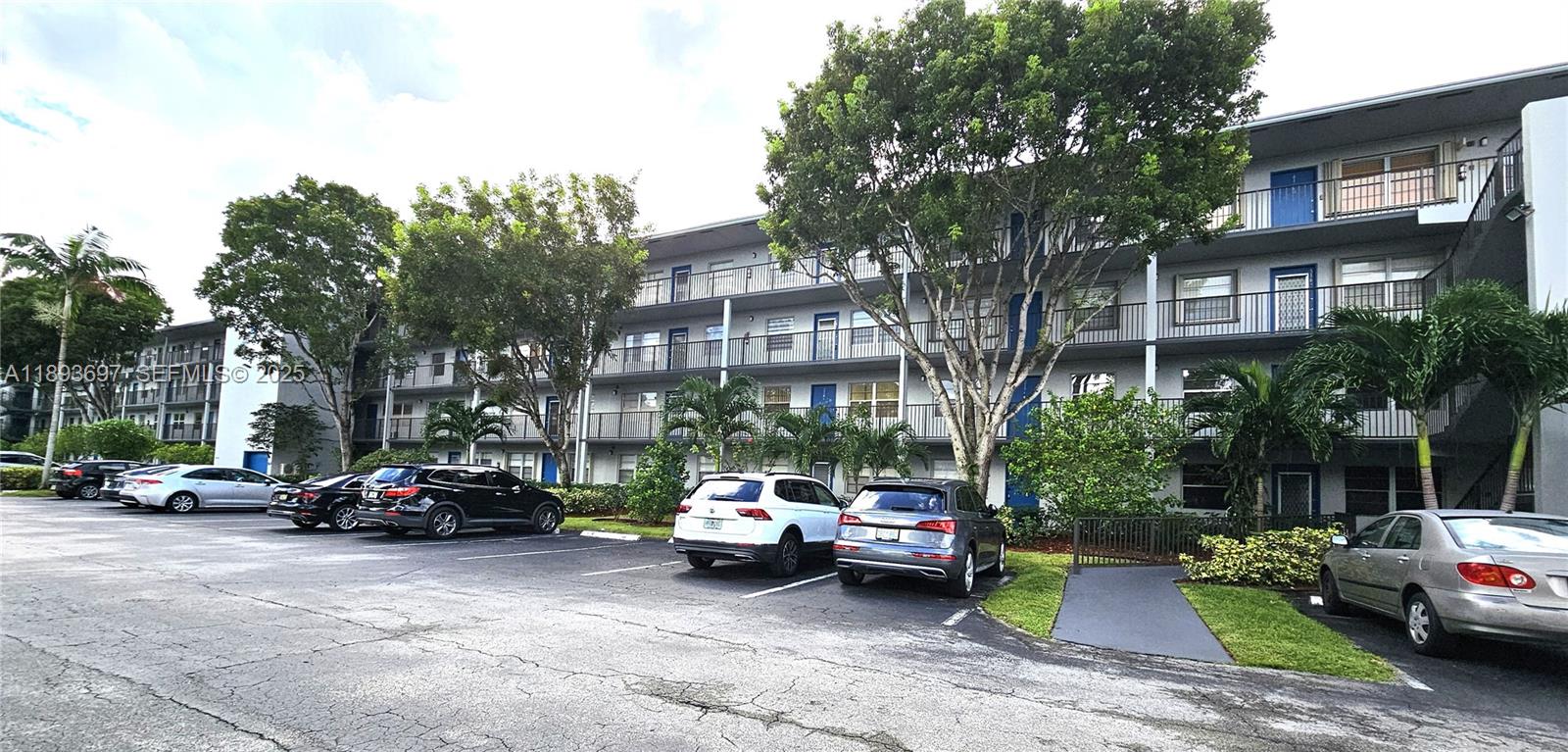13450 Southwest 3rd Street, Unit 415D Pembroke Pines, FL 33027 - Photo 15 of 15 a car parked in front of a brick building