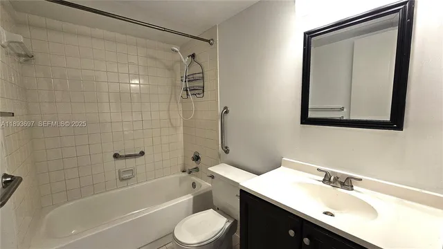 a bathroom with a bathtub shower sink mirror vanity and a toilet